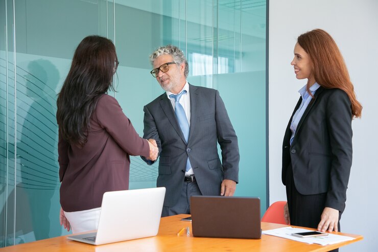 grey-haired-senior-manager-handshaking-greeting-businesswoman_74855-9937